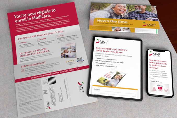 Self mailer on grey, granite counter top with a black tablet and cell phone displaying an MVP landing page