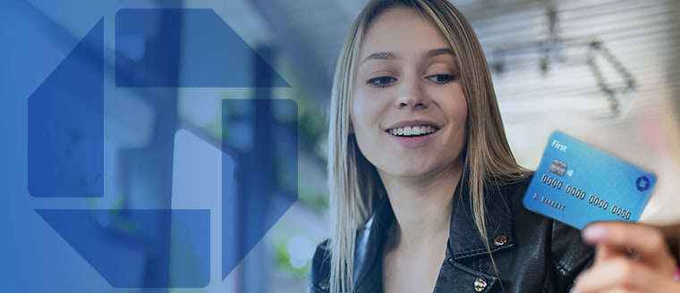 teenage girl with blonde hair smiling and holding a Chase debit card in front of a background with blue geometric shapes