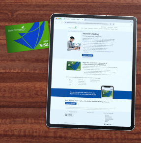 Visa DCCU Interest Checking landing page show on an iPad with the DCCU Visa debit card to its left