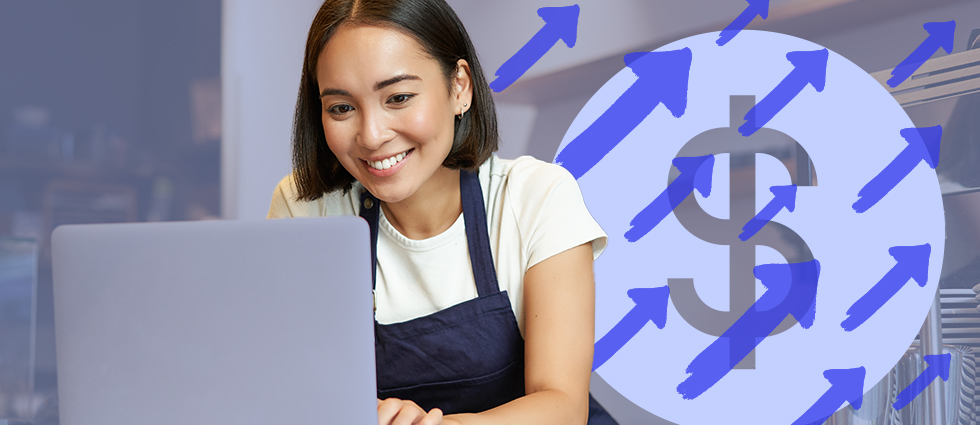 A smiling young woman with shoulder-length dark hair sits at a laptop computer, wearing a white t-shirt and dark apron or overalls. Behind her is a stylized graphic overlay featuring a large dollar sign symbol surrounded by blue upward-pointing arrows, suggesting forward-flow funding. The background appears to be a modern office or workspace setting.