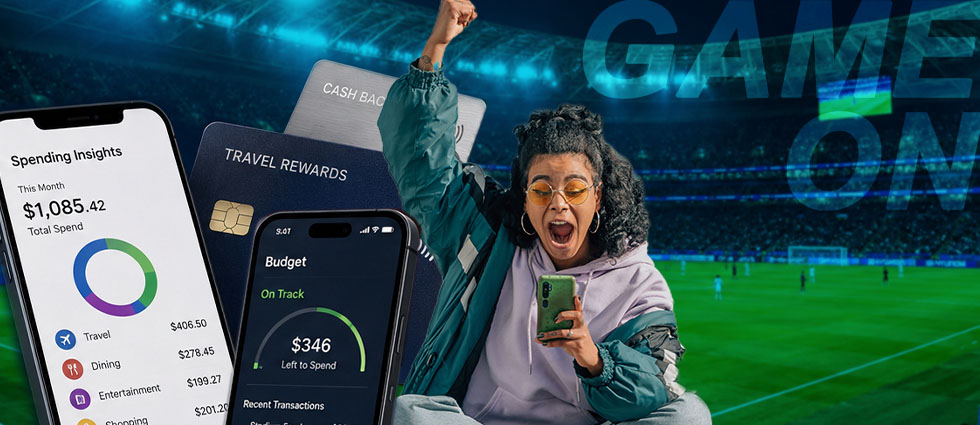 A womn cheering for the world cup while looking at a spending app on her phone.